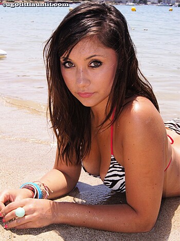 """
Busty blonde babe baring her booty on the sandy shore.
""