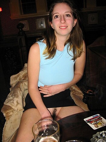 A fucking hot naked chick sits on a stool, legs spread wide open, and sips her drink like she doesn't give a shit.