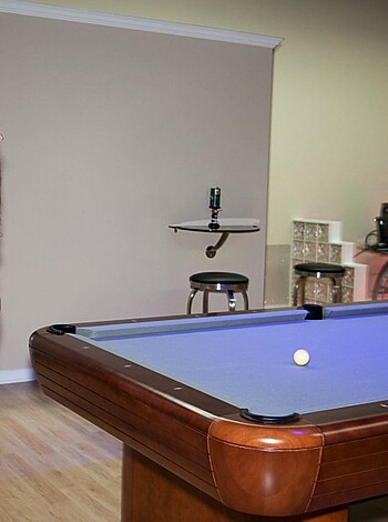 A fucking nude chick next to a billiard table, eye-fucking some fully-clothed bitch who's grinning like a cunt.