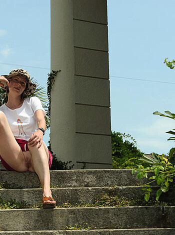 "Fucking hot chick sittin' on stairs, wearing tight-ass white tee n' shorts, legs spread wide open."