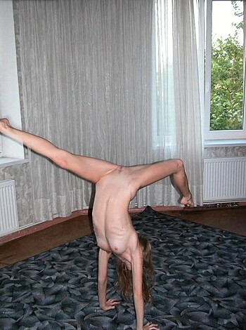"Here's a picture of some babe doin' a fucking handstand, her ass up in the air, while she balances on one hand against a plain old wall with a rug on the ground."