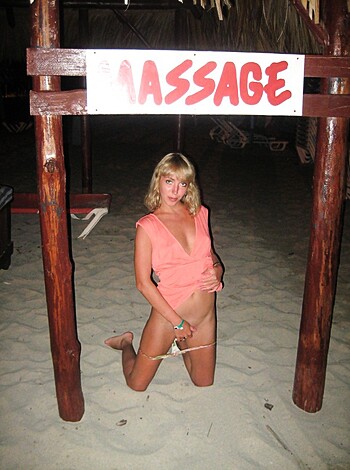 A bitch squats by the seashore with a fucking ad for her bone-snapping rubdowns in plain view.