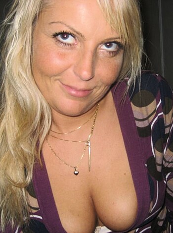 A picture of a smoking-hot chick with massive tits, flaunting her nips while giving the camera a slutty look.