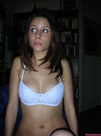 Here's a description of a busty blonde chick sporting a tight-ass white bra, probably panties too, as she gazes towards her left tit.
