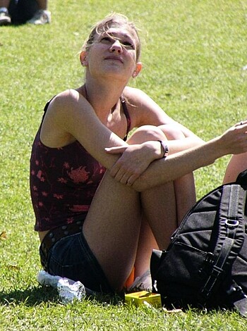 "Here's a hot chick in a tight ass tank top and shorts, basking her tits in the sun on some green shit."