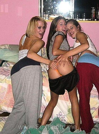 """
Three hookers taking a photo in a whorehouse; tits hanging out, coochies on display.
""