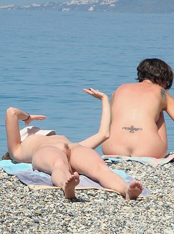 """
A couple of bare-assed bitches chilling on the beach.
""
