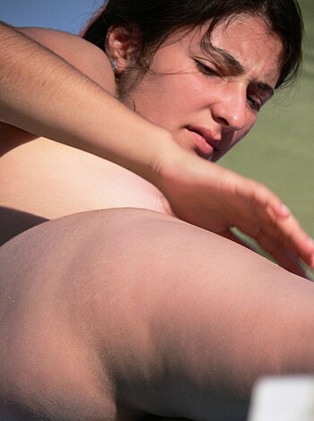 "You can see a cunt-less woman lying on the sandy shoreline, tanning her pussy and her saggy boobies."