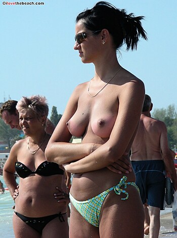"""
A busty blonde chick flaunts her tits and ass on the sandy shore, giving you a perfect view of her pussy.
"""