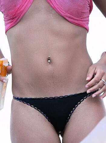 "Fat broad in a tiny bathing suit showing off her swollen belly."