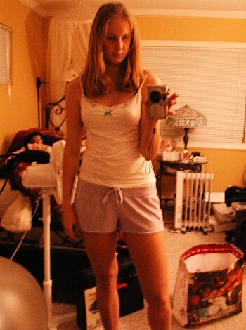 "Here's a hot chick snapping pics of her tits while fucking around in her bedroom."