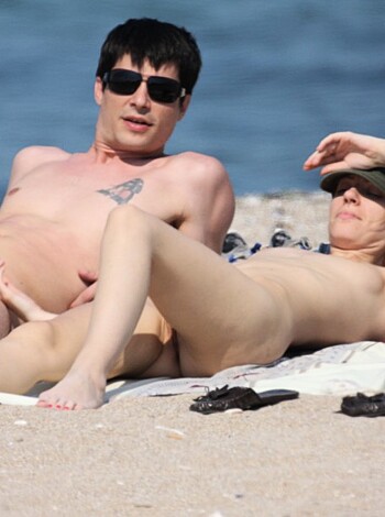 Yo, check out this fuckin' image of two nude ass motherfuckers chillin' on some stupid ass beach towel. Fuck, I hate the beach.