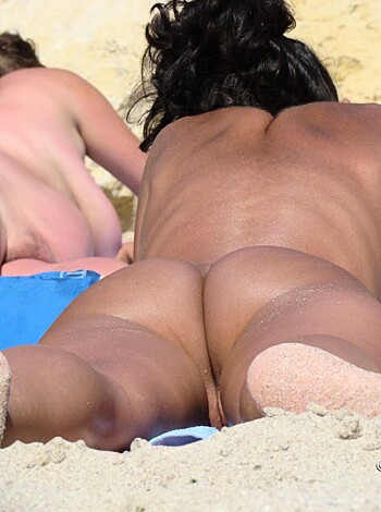Here's a picture of some hot bitch sunbathing on a beach with her skimpy bikini.