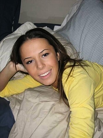 This here chick is all laid out in a yellow tee and shorts, grinning like a fucking idiot as the camera ogles her tits and snatch.