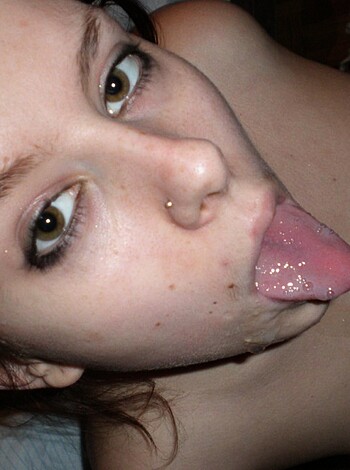 A bitch with tongue out suckin' on her titties in some sexy shit.