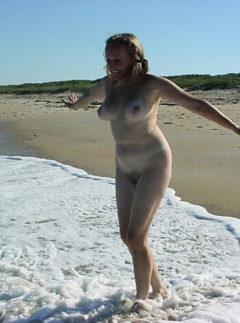 Vulgar description: "Here's a picture of a hot ass bitch lying nude on the sand, fucking showing off her tits and pussy in public."