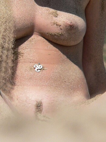 "Ugly fat bitch in dirty panties squats on beach sand with saggy tits, no bra and hairy bush hanging out."