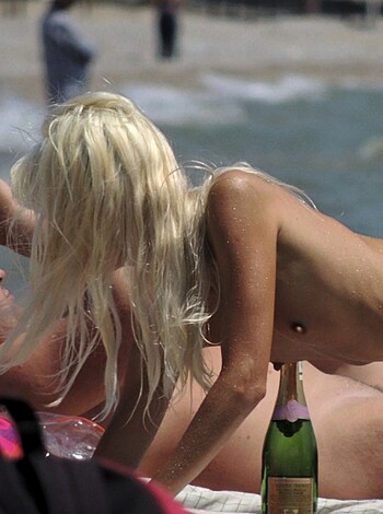 Vulgar description of image:
This fucking picture shows an unclothed bitch sucking cock on the goddamn beach with her pussy lips wrapped around the dick like a goddamn pro.