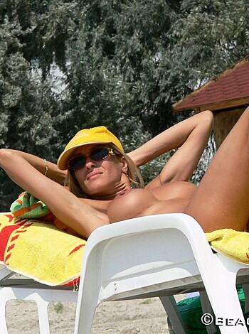 "Here's your typical dumb blonde, lying on the sand with her tits out and no fucking clue."