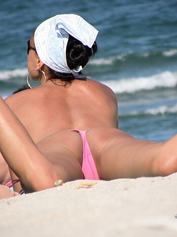 Here's a caption for that pic - "Fuckin' hot ass babe with her shitty bikini bottoms, lying on the fucking sandy shore of the goddamn beach."