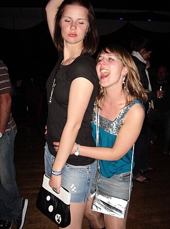 A pair of bitches grinding on the dance floor with one hoe being lifted up in the air like a fucking freak.