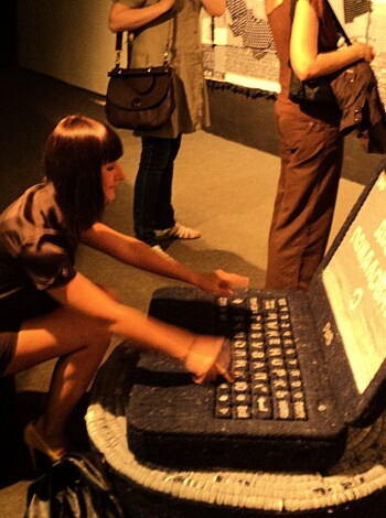 This chick is pounding away at her bitchin' blue computer keyboard like fucking mad, all sexy-like. She's probably sendin' nude selfies to some dude she met on Tinder, or maybe checking out dick pic submissions for the next "Girls with Dongs" calendar. But whatever this babe is doin', she looks like one hot tech geek.
(32 words)