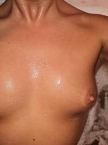 Here's a fucking pic of a bitch taking a shower with her tits and pits out for all to see.