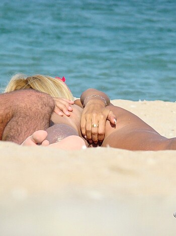 Here's a fucking hot-ass picture of some nude bangin' ass motherfuckers getting cozy as shit on a goddamn sexy-ass beach, man!