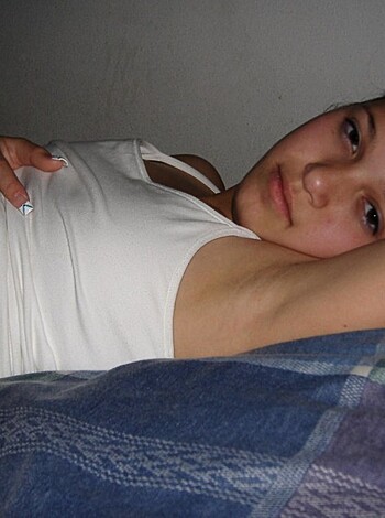 A naked bitch lies on the ground with her hand on her tits, showing off her sexy ass in this dirty as fuck pic.