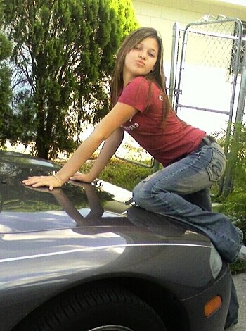 Vulgar description of image:
"Hey dude, check out this bitch taking a pic next to some douchebag's car while she shows off her hot ass in some tiny denim shorts and a fucking red t-shirt. You know you wanna suck them titties."
