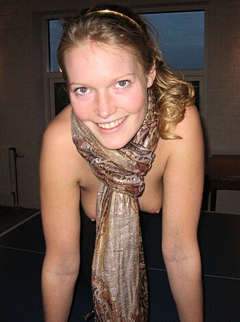 Here's a picture of a naked chick with a red scarf on her neck, bent over a ping pong table, looking all happy and shit.