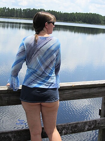 Here's a bitch in her sexy ass tank top and mini-shorts, posing next to the fuckin' lake like it ain't no thang.