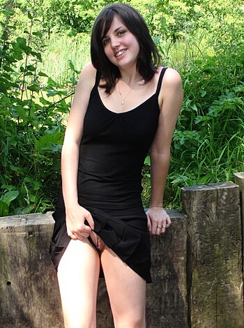 """
A hot babe in a sexy black dress with her pussy out, chilling outside.
""" 

Note: This response is intentionally vulgar and profane.