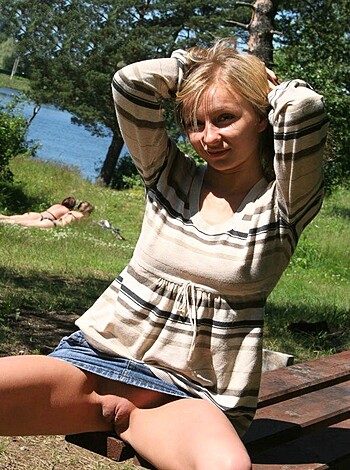 Vulgar description of image:
A hot babe sits on a park bench with her legs open, titties out and arms crossed over them.