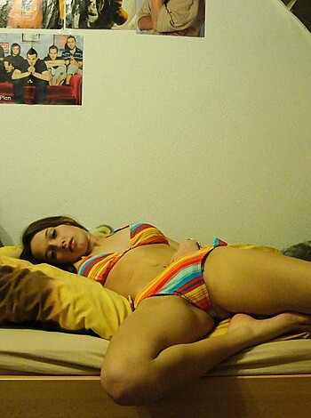 "Fucking hot chick in a skimpy bikini, legs wide open on a bed."
