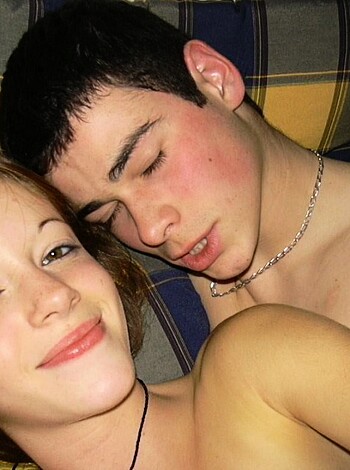 Here's the nude, horny couple fucking on their mattress, grinning, smooching.
