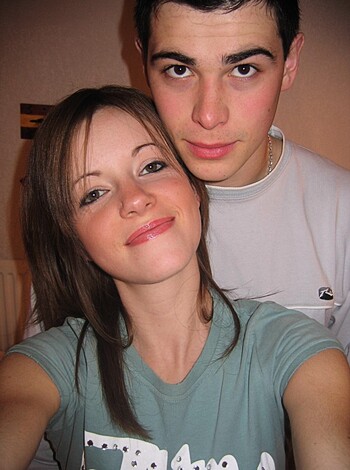 This f**king image shows a hot chick and some d**k holding each other tight.