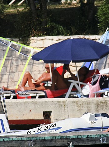 A naked couple banging at the swimming pool bar, while enjoying some beers and getting frisky.
