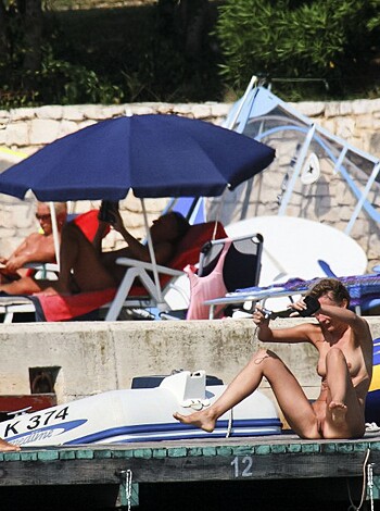 "Check out these dudes in tight ass shorts and no shirts standing by some sweet ass speedboats."