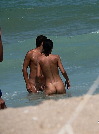 "Check out this image of three horny assholes at the fucking beach: some dickhead's taking off his ass-cracker while he checks out some other dude's dong, all while their buddy watches and jerks off."
