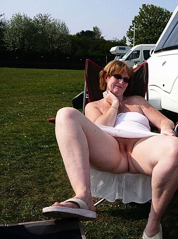 A fucking naked bitch is chillin' on some outdoor ass shit.