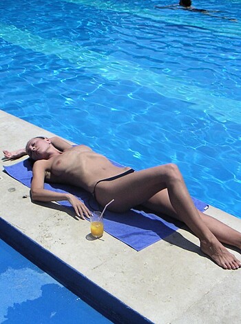 Vulgar description: "Here's a hot fuckin' naked bitch lying on her back with her tits out, next to a swimming pool."