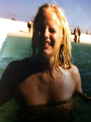 A hot piece of ass showing off her shiny bikini-clad tits and tight ass cheeks.