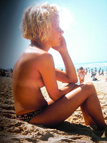 "Busty blonde chick tits out on sun-kissed shoreline."