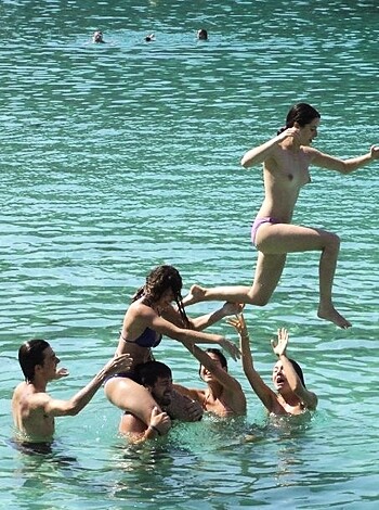 "Check out this fucking hot babe with her tits out jumping over a bunch of nerds getting soaked in some goddamn pond."