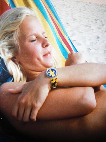 "Here's a hot-ass bitch in a bikini with tits hanging out, getting a tan on the sand."