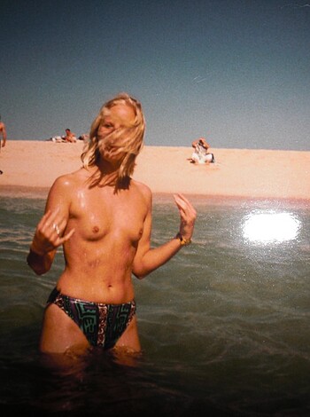 """
A hot babe showing her tits off at the beach.
"""