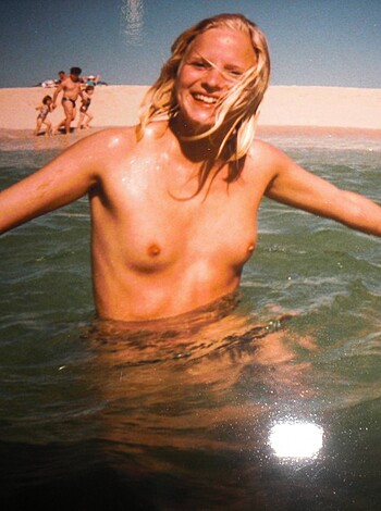 A woman with her tits out, bouncing around on the sandy shore, rocks a fucking blinged-out necklace and arm candy, as she chills at the beach.