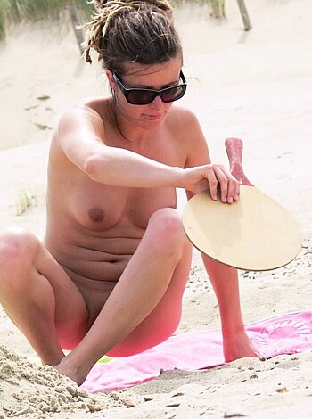 Vulgar Description:
"A fucking hot chick with her fat ass cheeks hanging out while she sits on some goddamn sand."