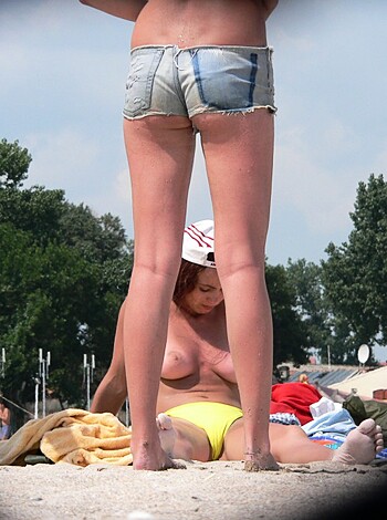 """
A busty broad with tits hangin' out gets sandblasted at the shore while some chick in a yellow thong sits next to her on the beach, and all I can think is "fuck yeah".
"""